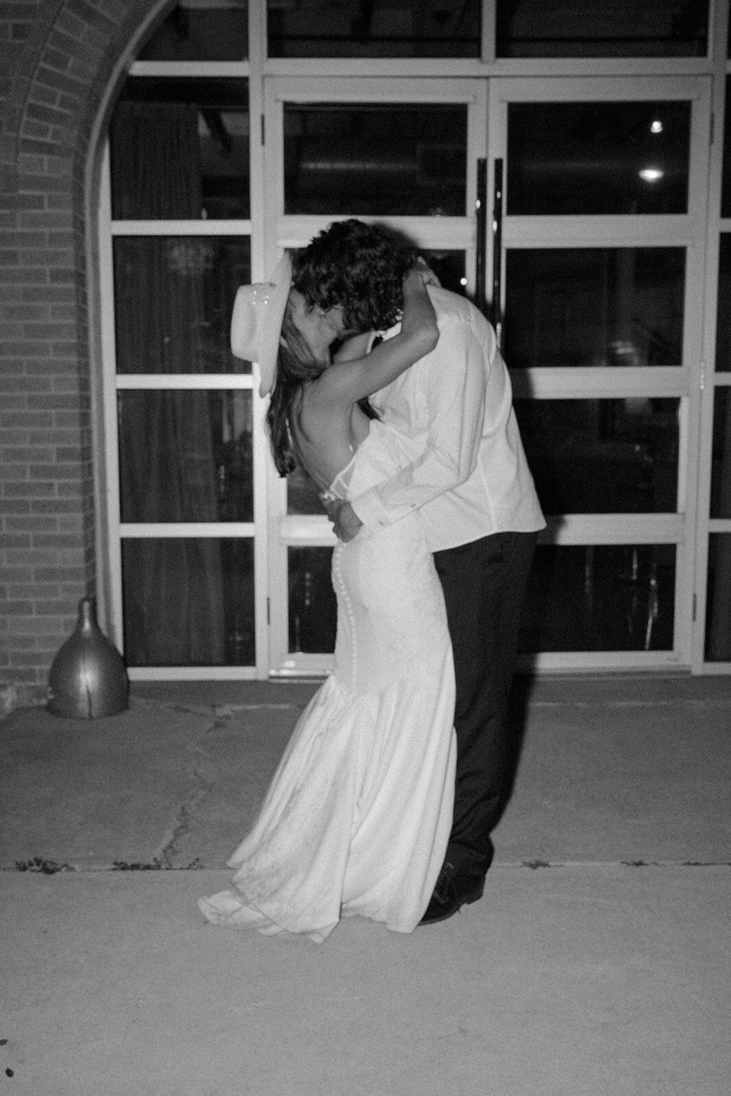 Bride and groom sharing final private moment at the close of reception