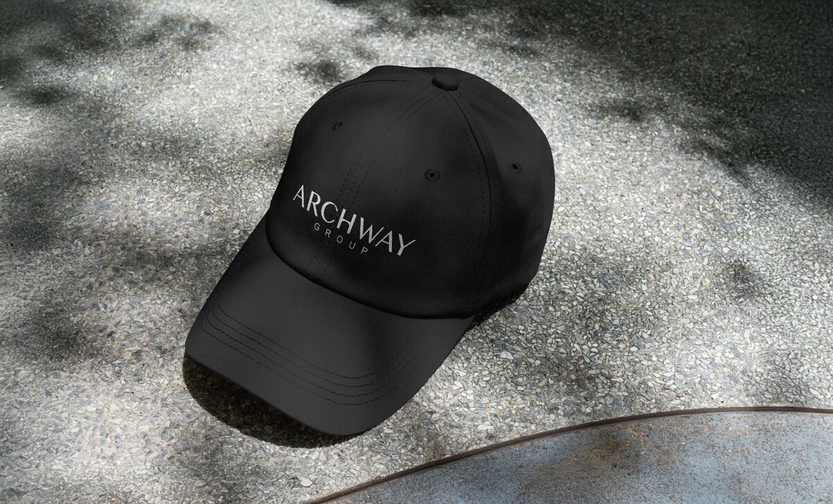 Black baseball cap with Archway Group logo embroidered in white.