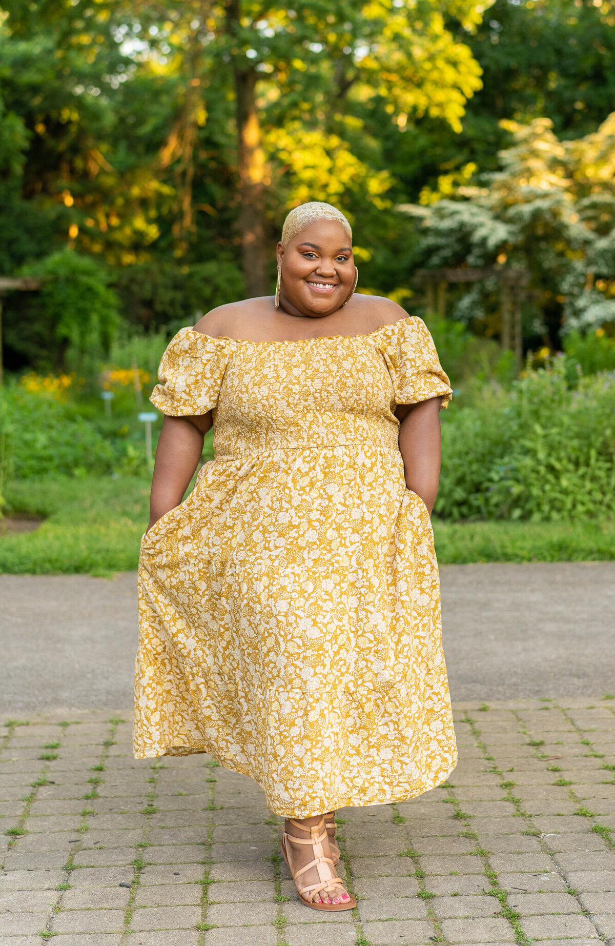 Candace Cooper showing off her beautiful yellow off-the-shoulder dress with pockets at the Columbus Park of Roses.