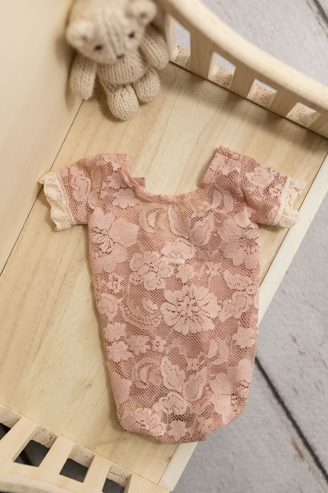 Delicate pink lace onesie for newborn photography sessions by Jennifer Brandes.