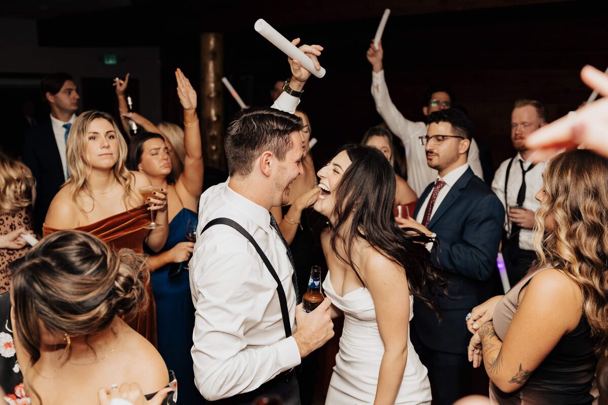 Couple Laughing on Dance Floor at Wedding Reception