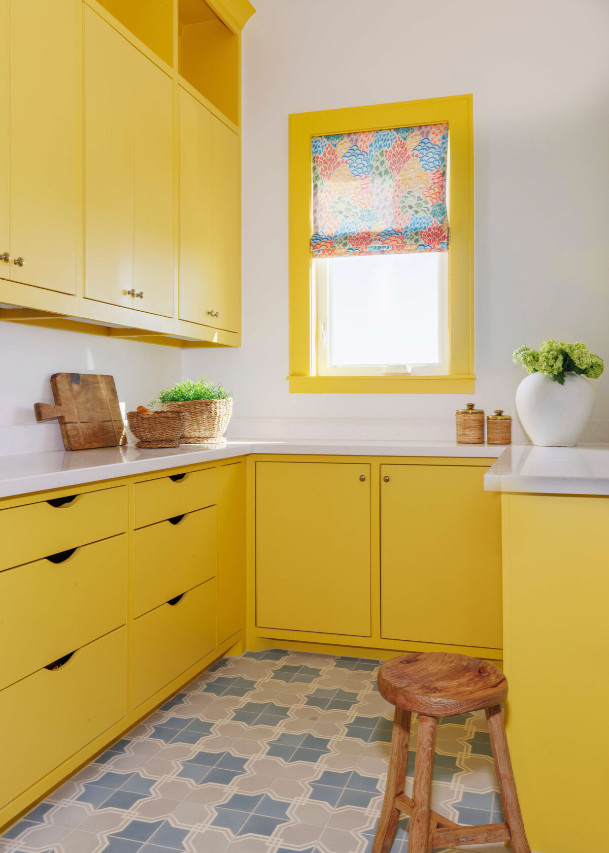 oyster creek studios lighthouse on the lake yellow cabinets with white marble counters in kitchen