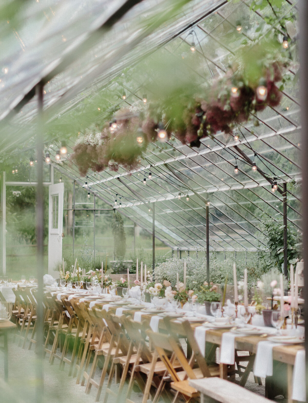 wedding dinner reception table in glass greenhouse, Grand Rapids wedding venue