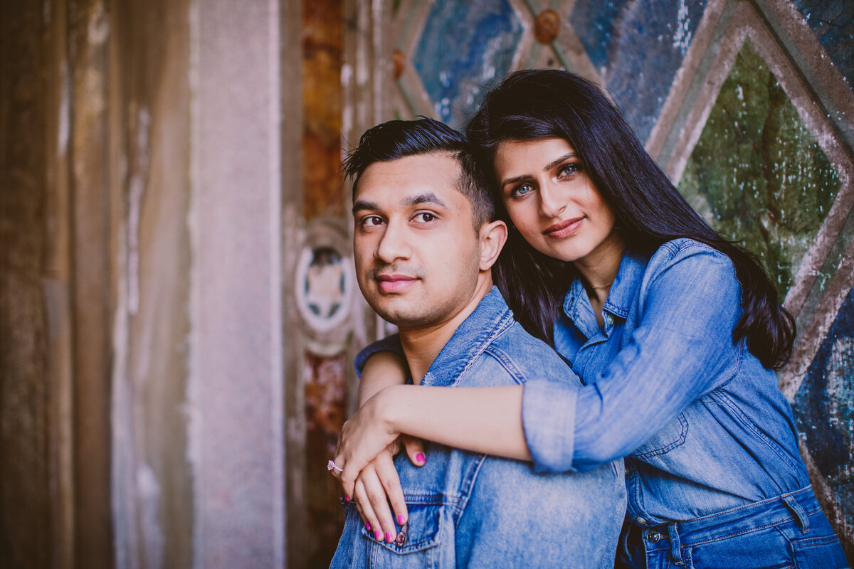 A couple in denim clothes standing at the mural in bethesda terrace at central park in nyc