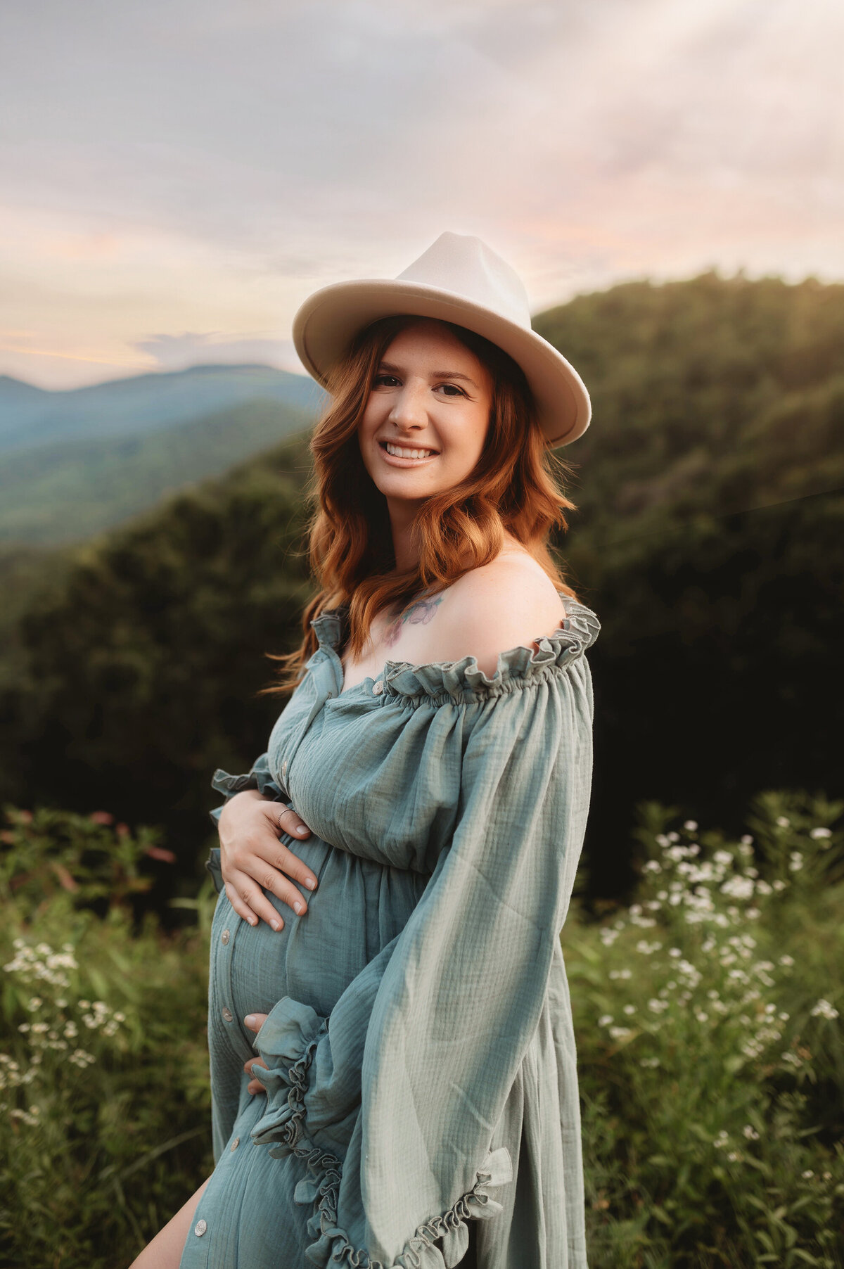 Expectant parents pose for Maternity Photos on the Blue Ridge Parkway in Asheville, NC.