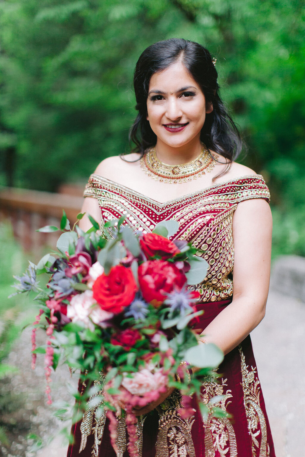 Indian wedding, red, gold and pink attire. Blue accents.