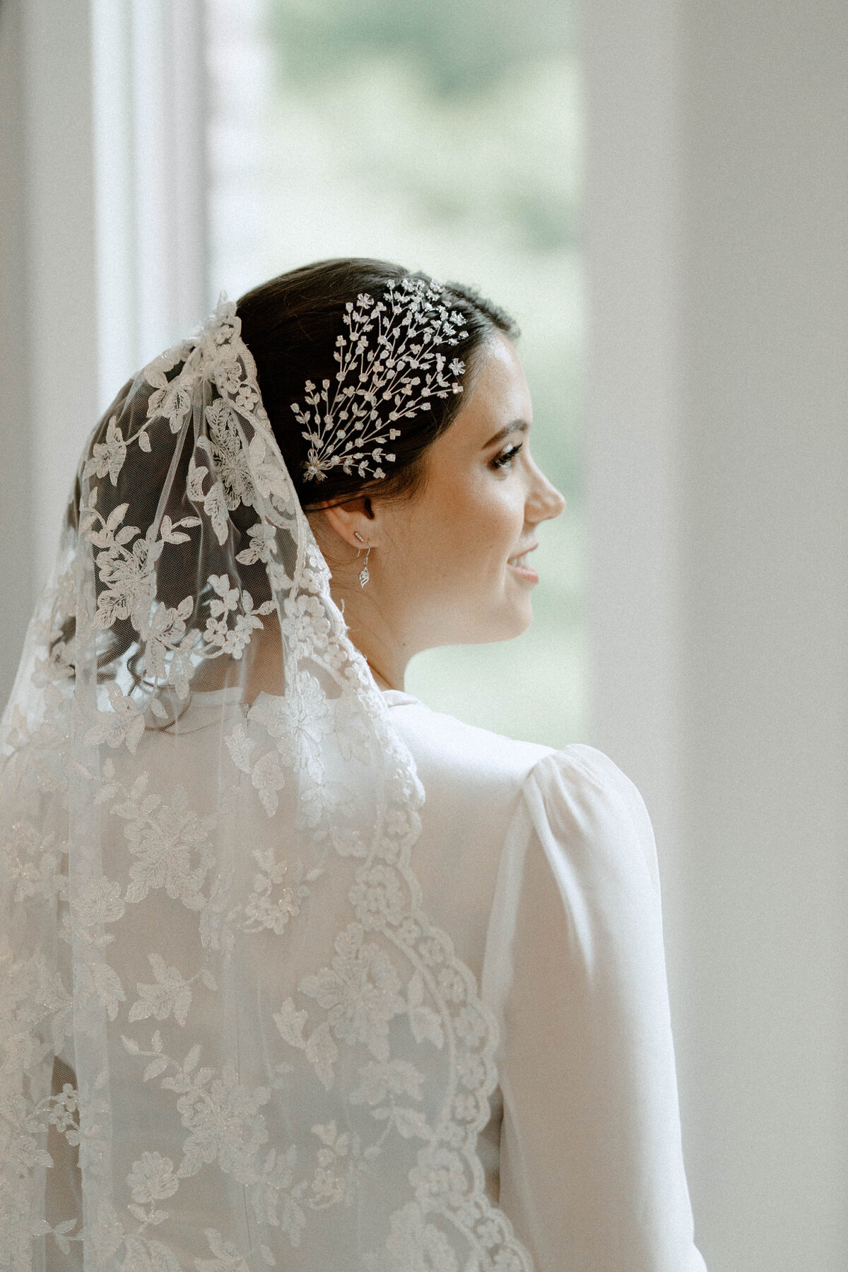 Back shot of the bride with her side profile showing as she waits for the wedding