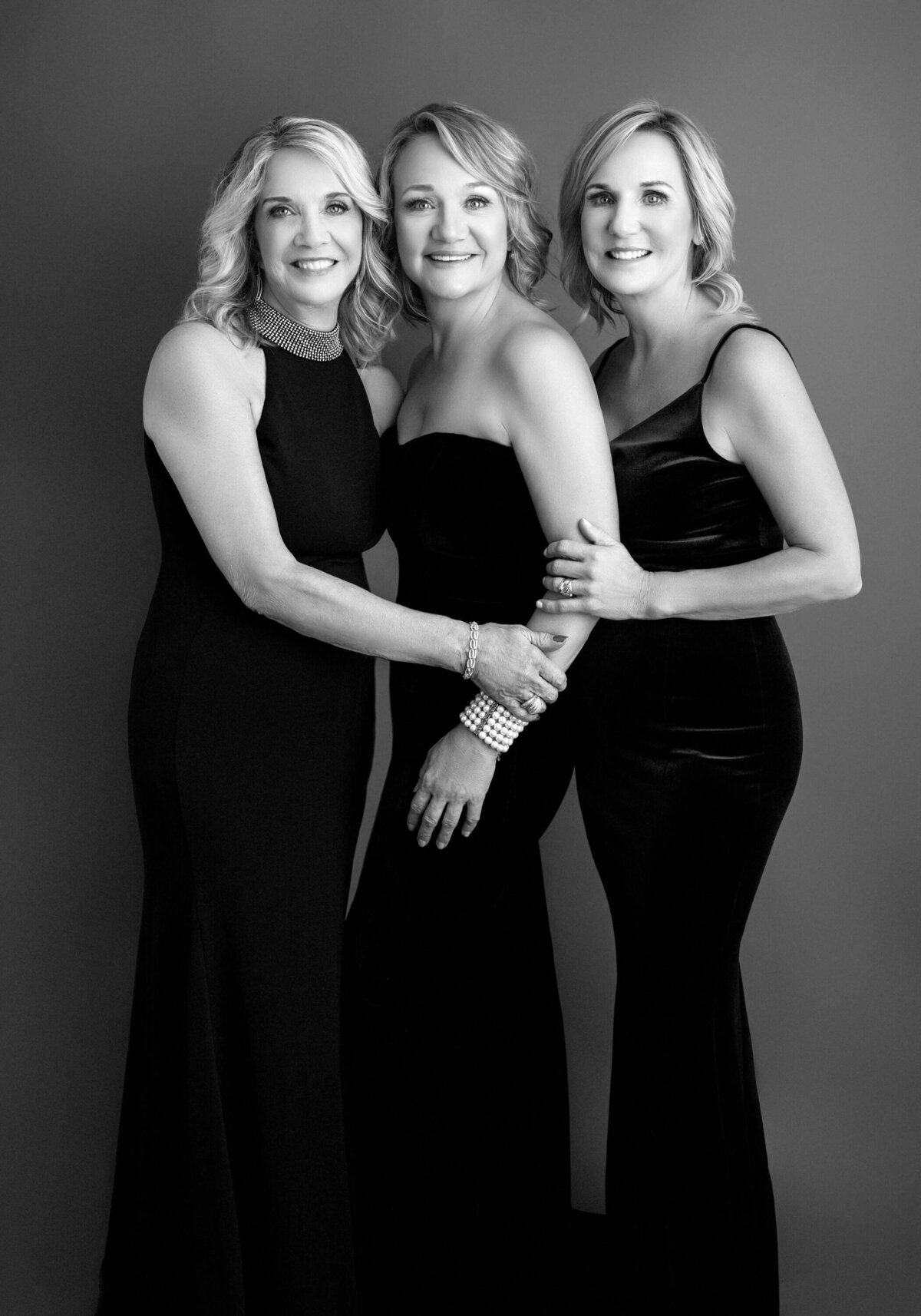 Elegant black and white sisters and mother portrait.