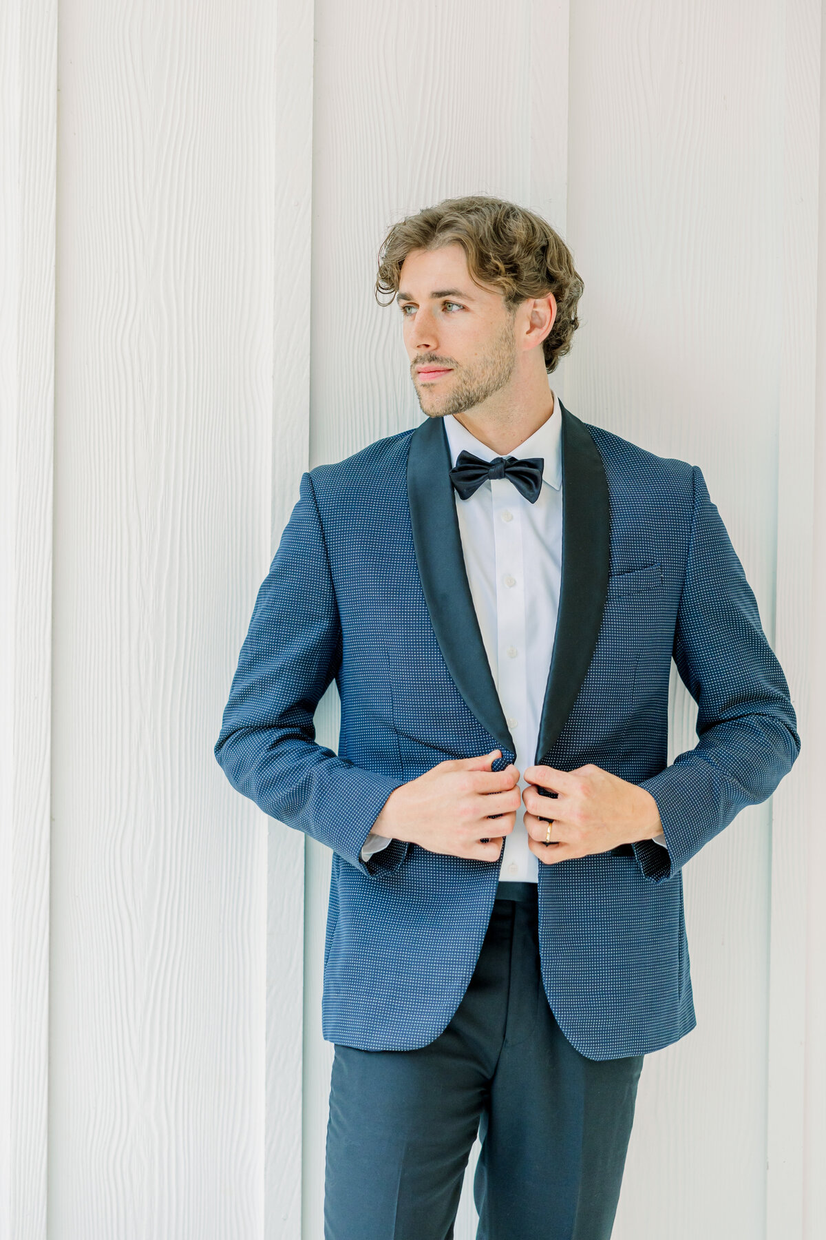 Groom getting ready portraits at the ivy rose barn