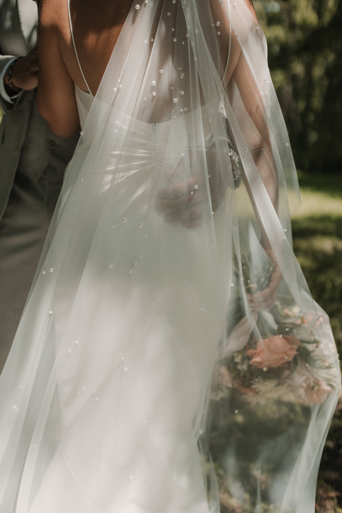 bride with veil over her flowers