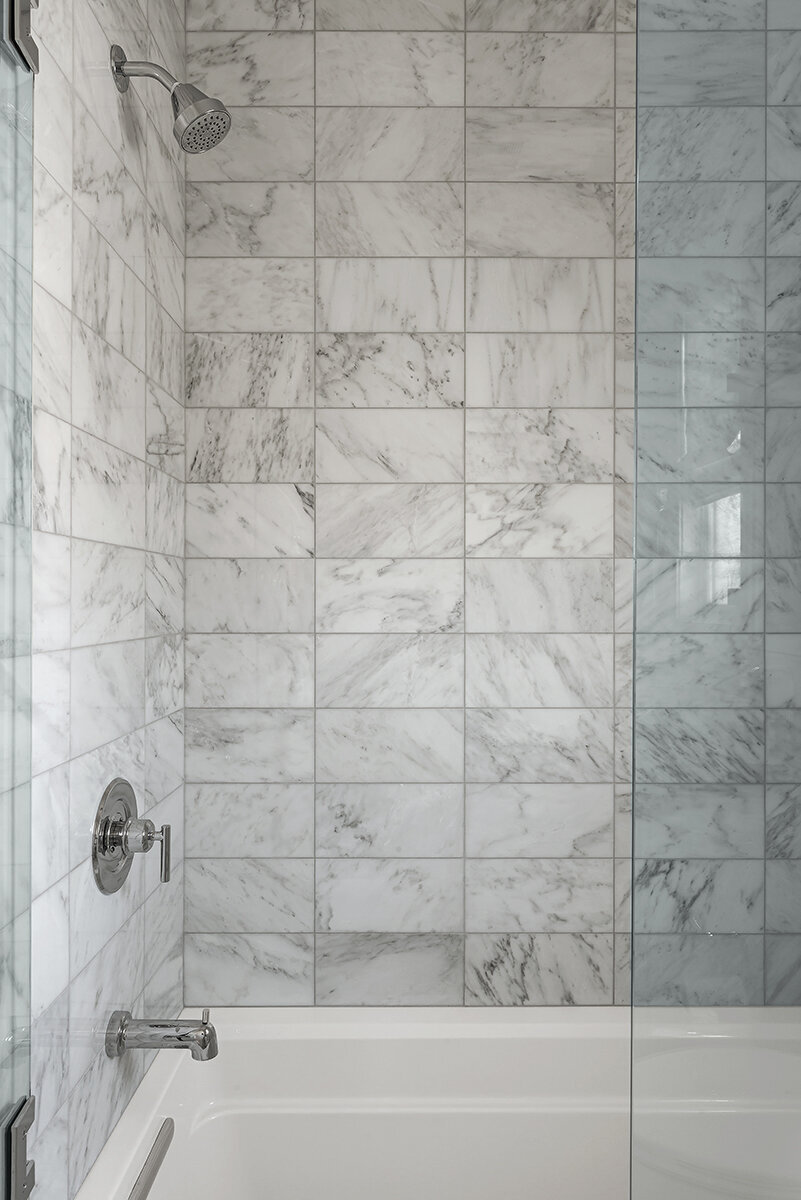 stacked marble tile shower walls