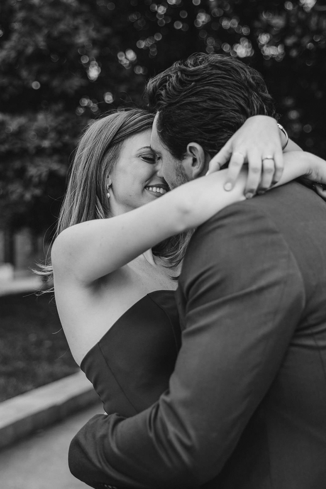 A couple with their arms around each other as they are about to kiss 