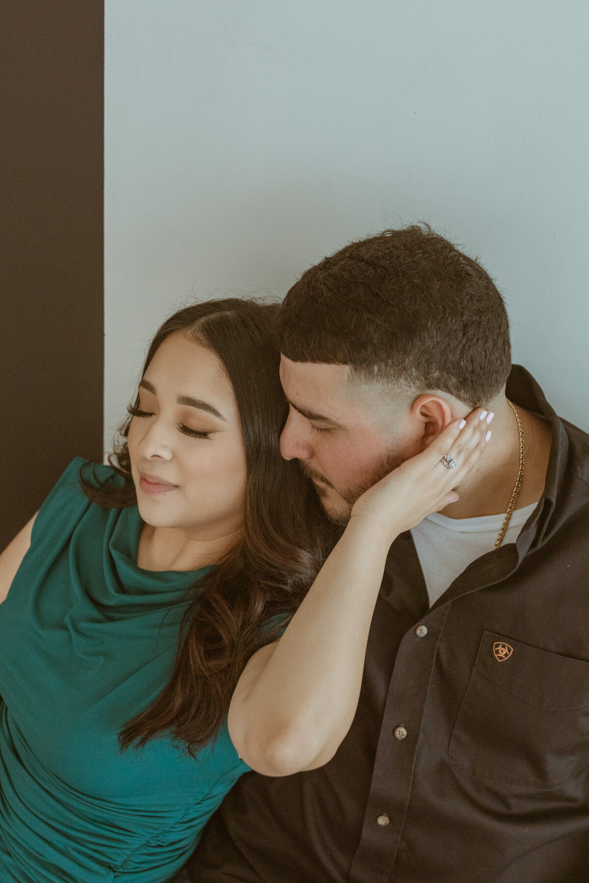 Nestled near downtown Houston, the studio where I photographed this engagement session boasted an urban loft vibe, perfect for capturing modern love stories. Against the backdrop of exposed brick walls and sleek furnishings, the couple's affectionate glances and tender embraces filled the space with warmth and intimacy, resulting in timeless photographs that reflected their unique connection.