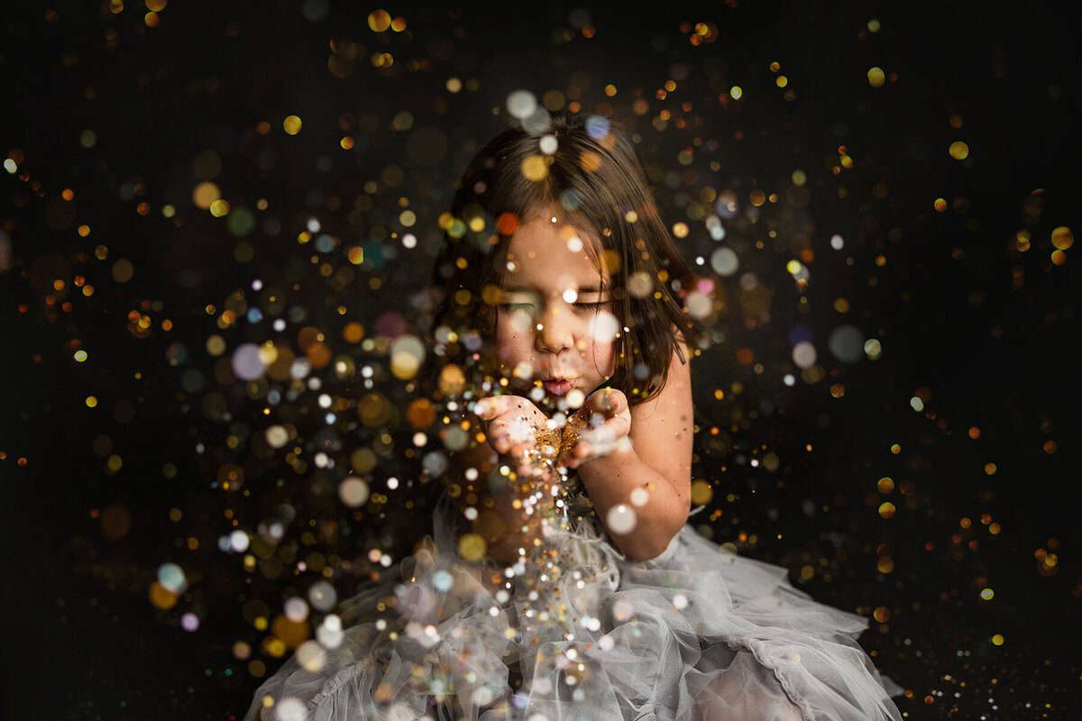 Amazing glitter session with little girl blowing glitter in Fort Collins, CO