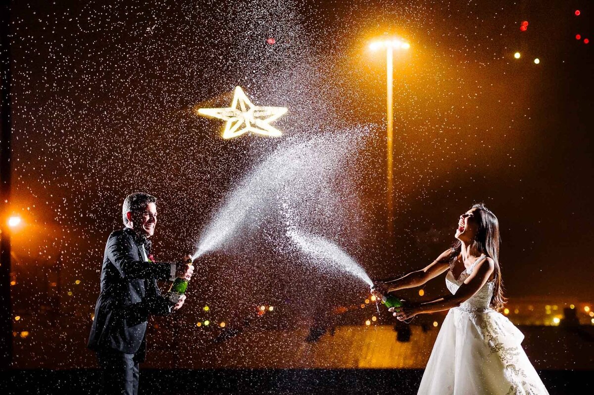 bride and groom celebrating with champagne bottle at epic railyard In el paso texas