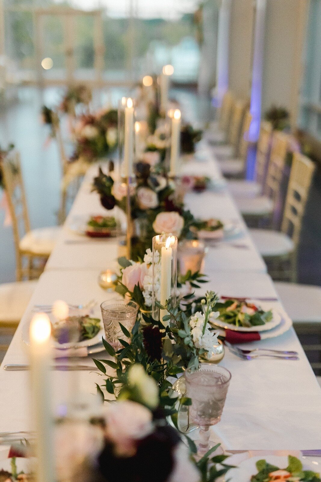 Elegant long table designed with flowers and candles