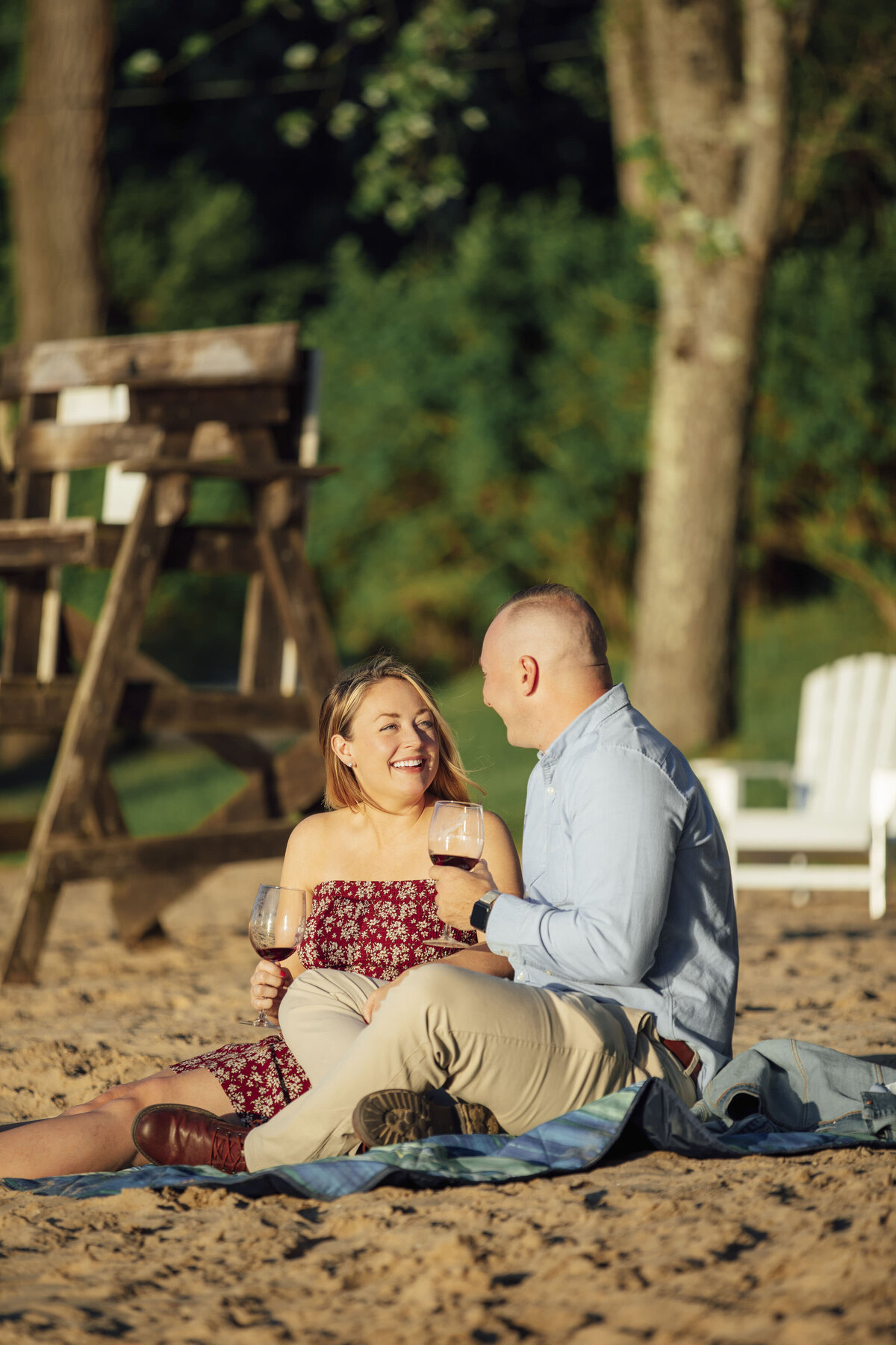 Proposal Photographer | Couple celebrating with champagne after engagement by the lake | Sparta, New Jersey