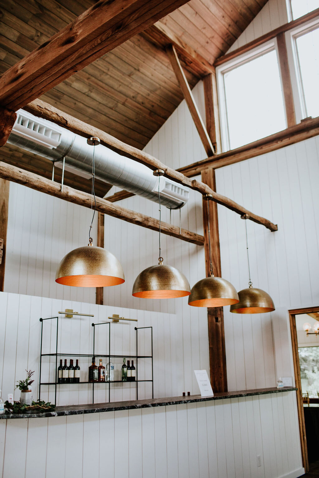 color image of the upstairs bar at Willowbrook Wedding venue with brass Crate and Barrell lights