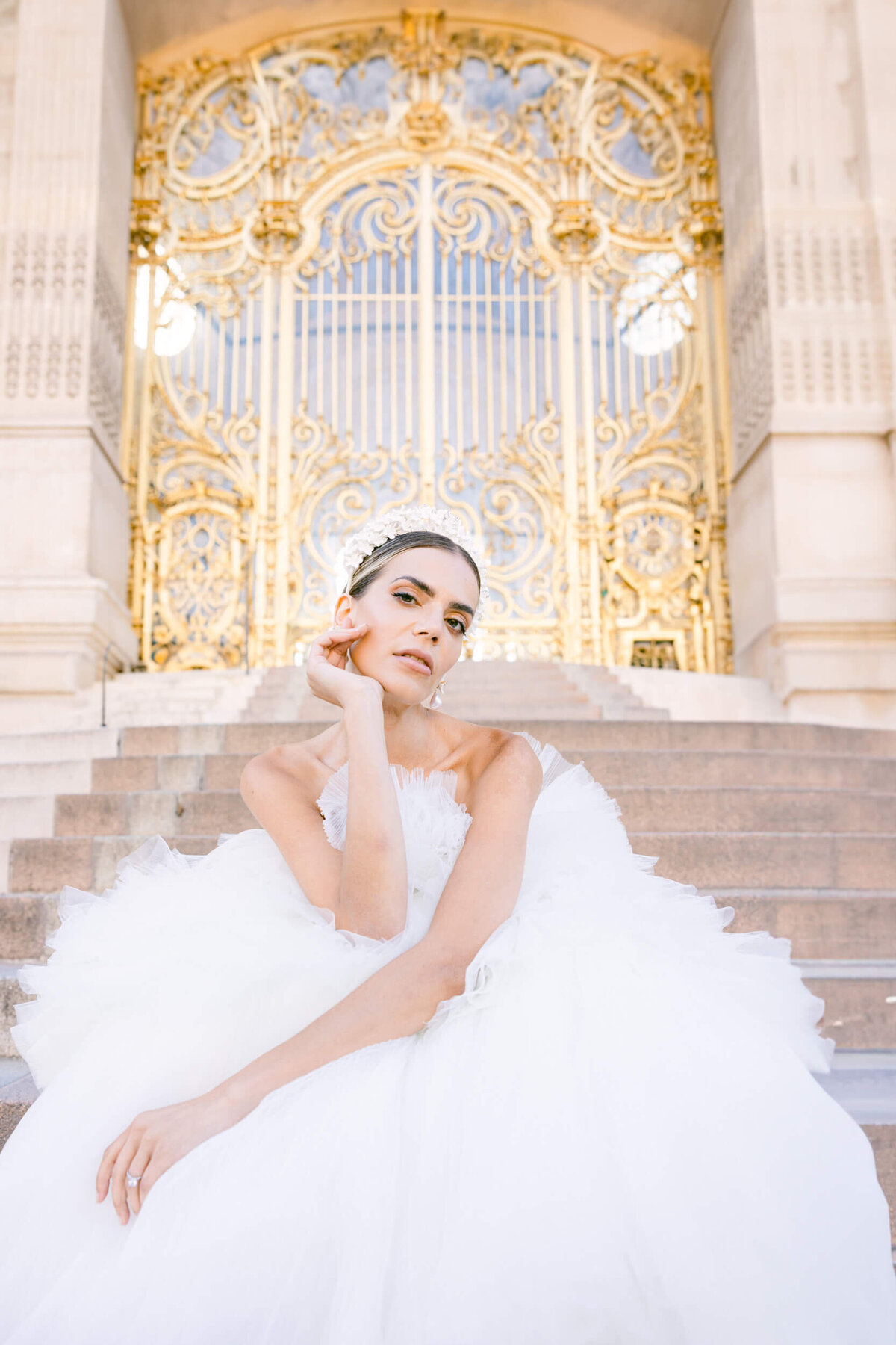 A wedding photo of a bride in her white dress in the streets of Paris in France.