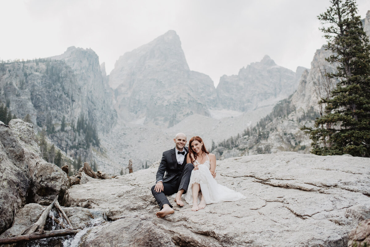 Jackson Hole Photographers capture couple sitting on boulder