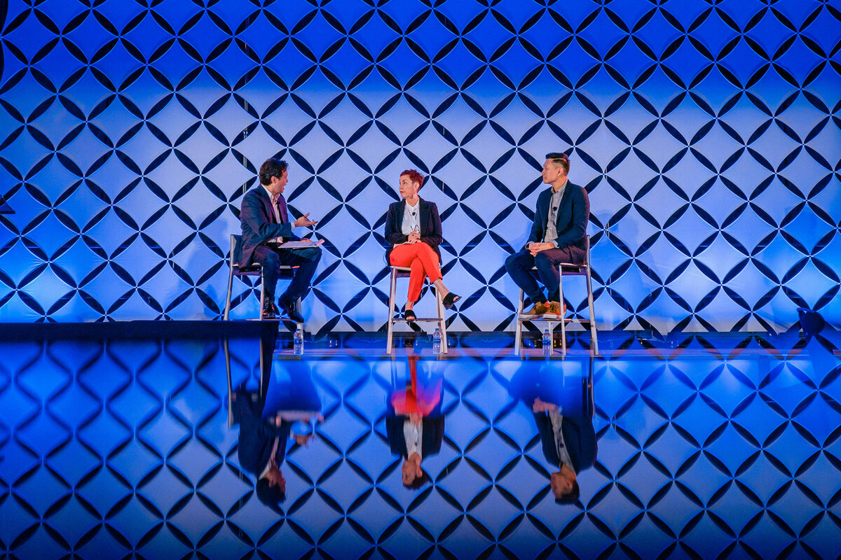 kansas-city-event-photography-0001-two-speakers-on-stage-with-blue-backdrop