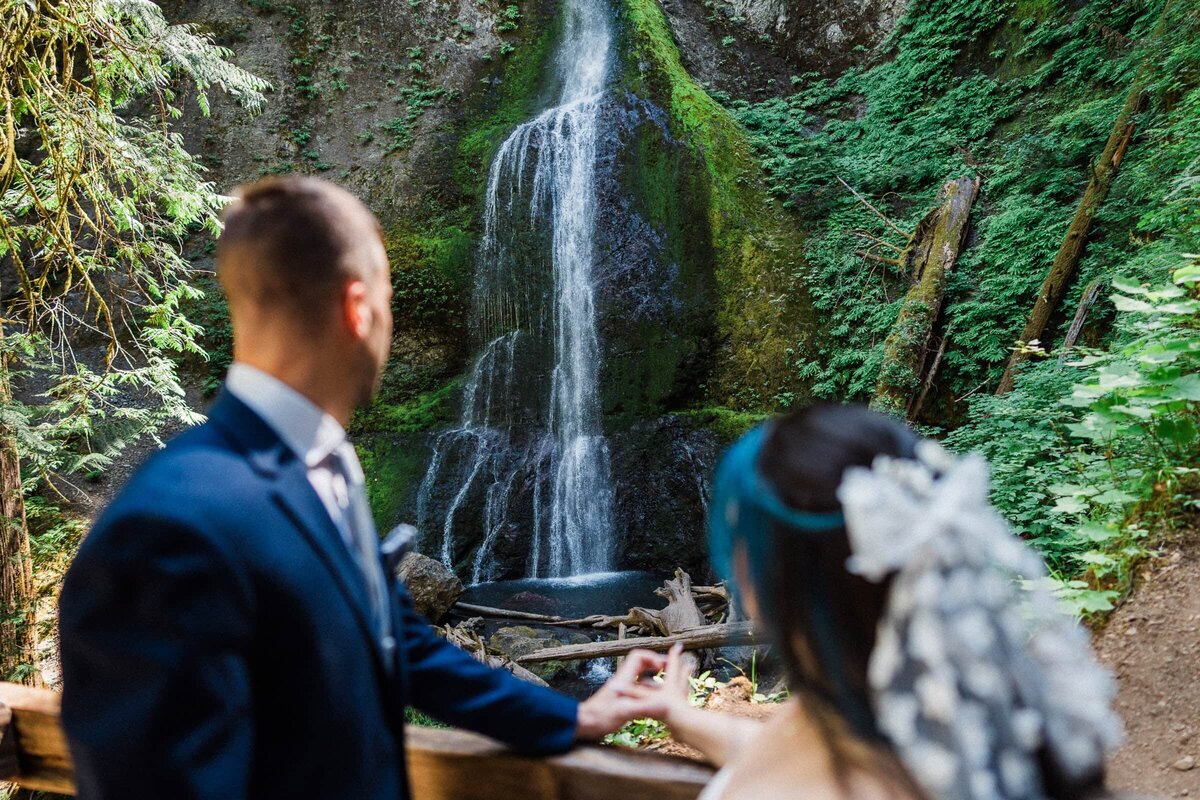 couple overlooking marymere falls during their elopement