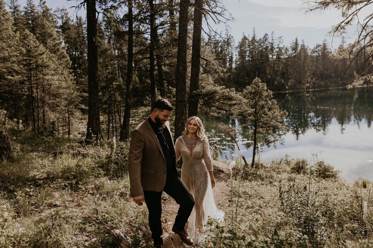bride and groom walking together in a forest