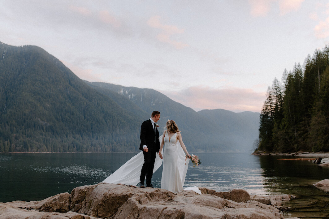 bride and groom on a rock