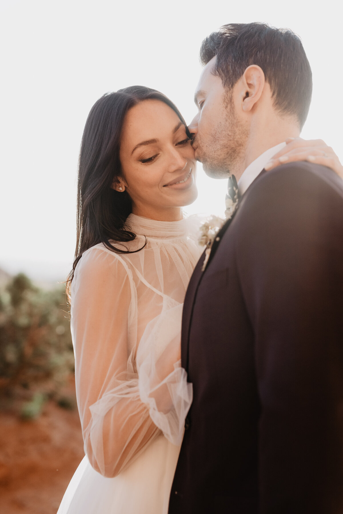 Utah elopement photographer captures sunset bridal portraits with bride and groom hugging