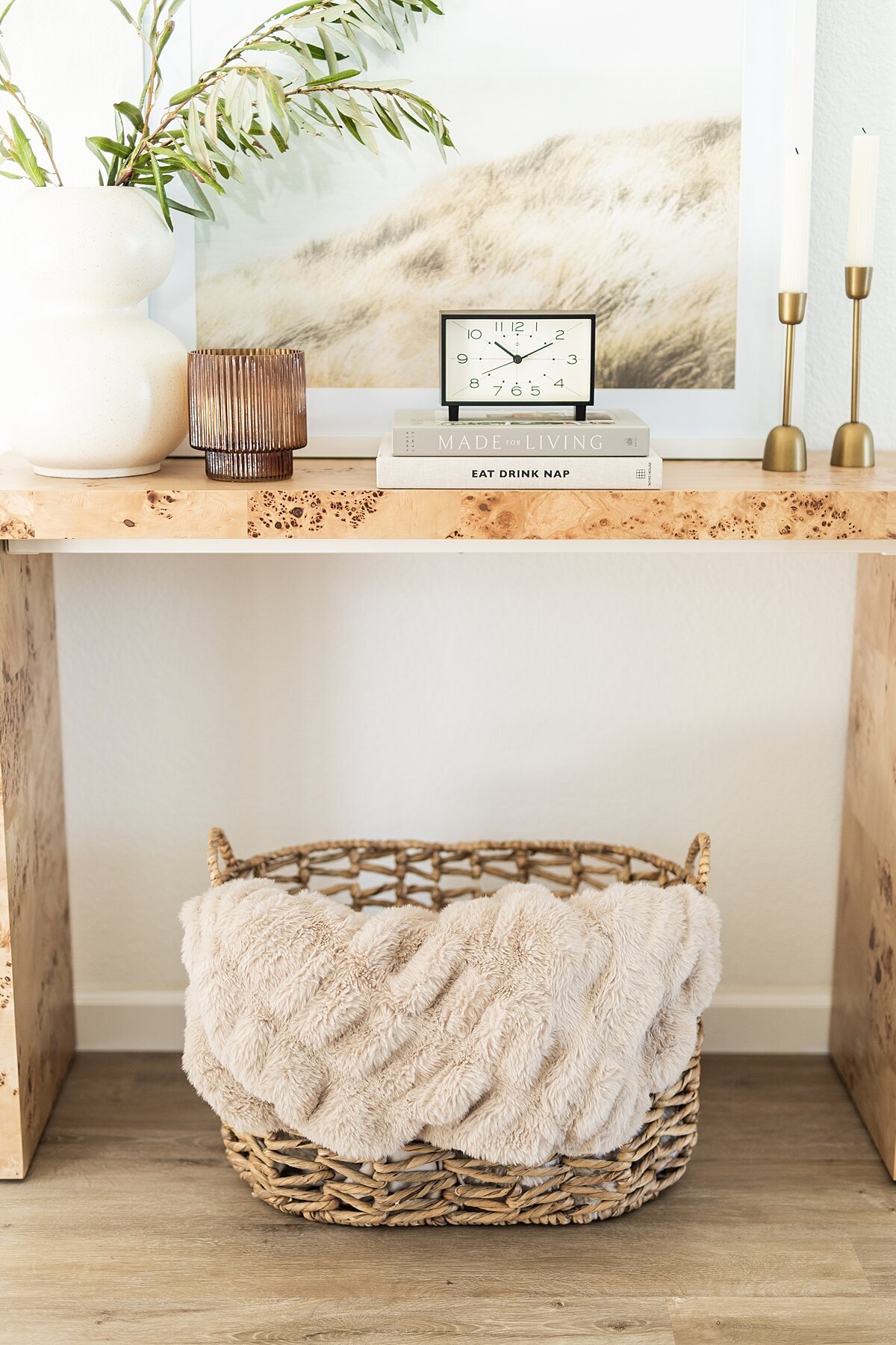 Console table with decor basket and natural decor.