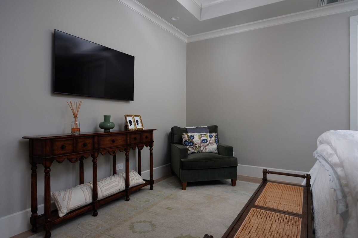 the keeping room interiors primera master bedroom with green corner chair