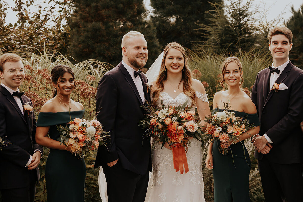 Couple standing with bridal party.