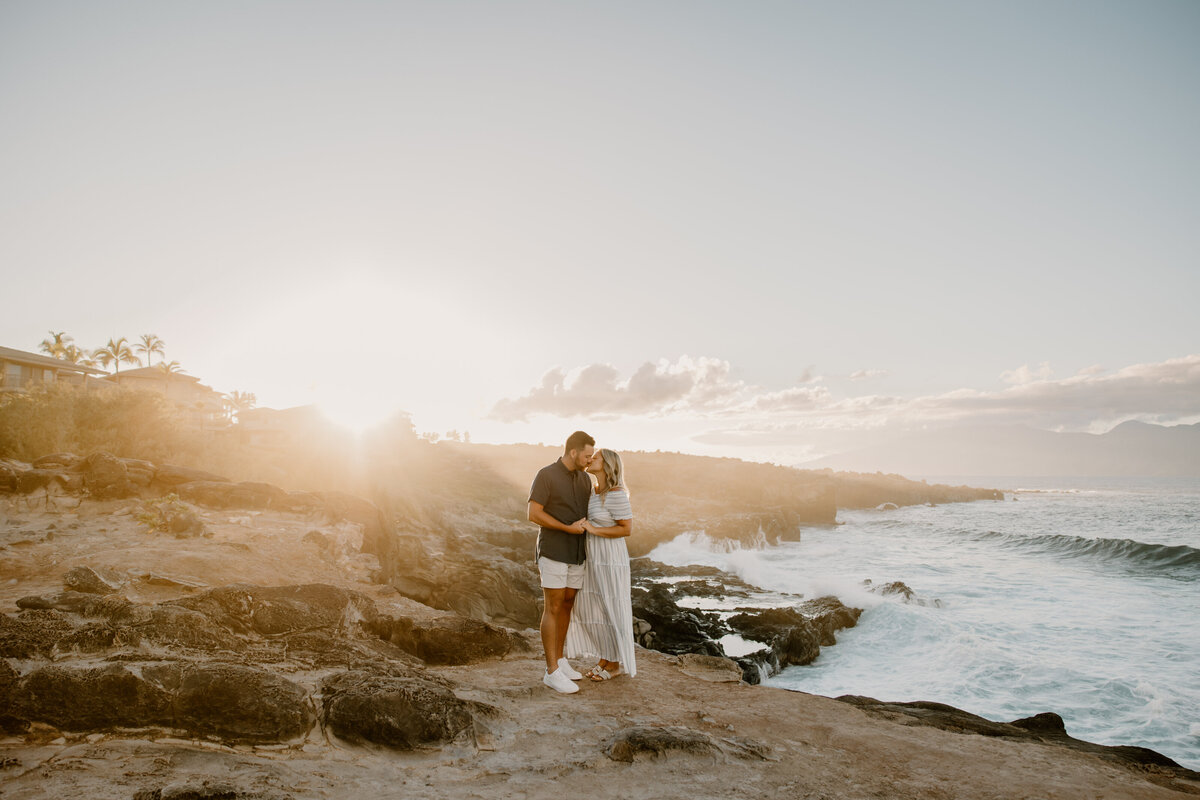 Hawaii Engagement Photographer captures man and woman holding hands on beach at sunset