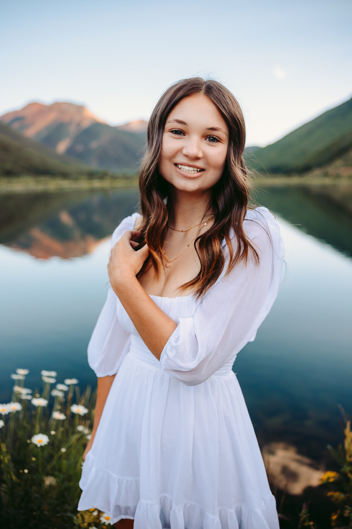 Maddie poses in front of a lake for her Telluride senior pictures.