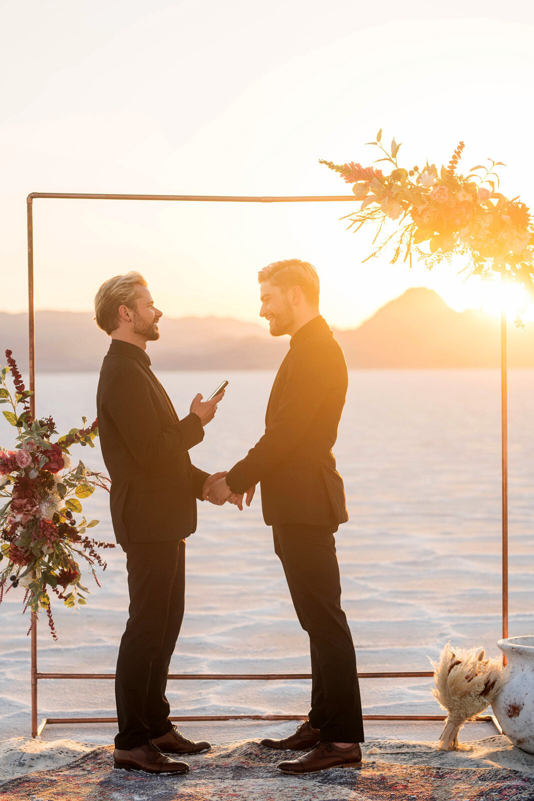 Grooms exchange vows at sunset ceremony