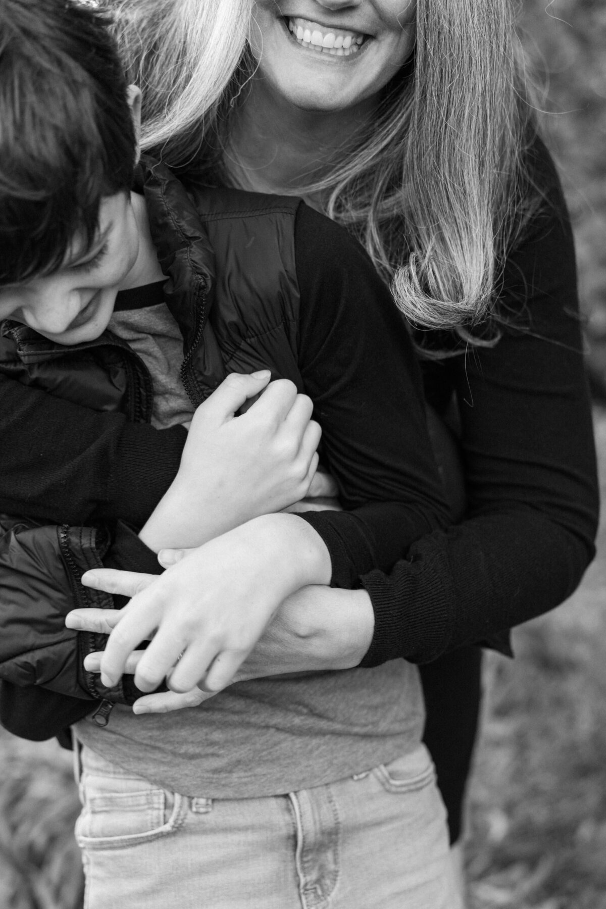 black and white photo of mother hugs her son