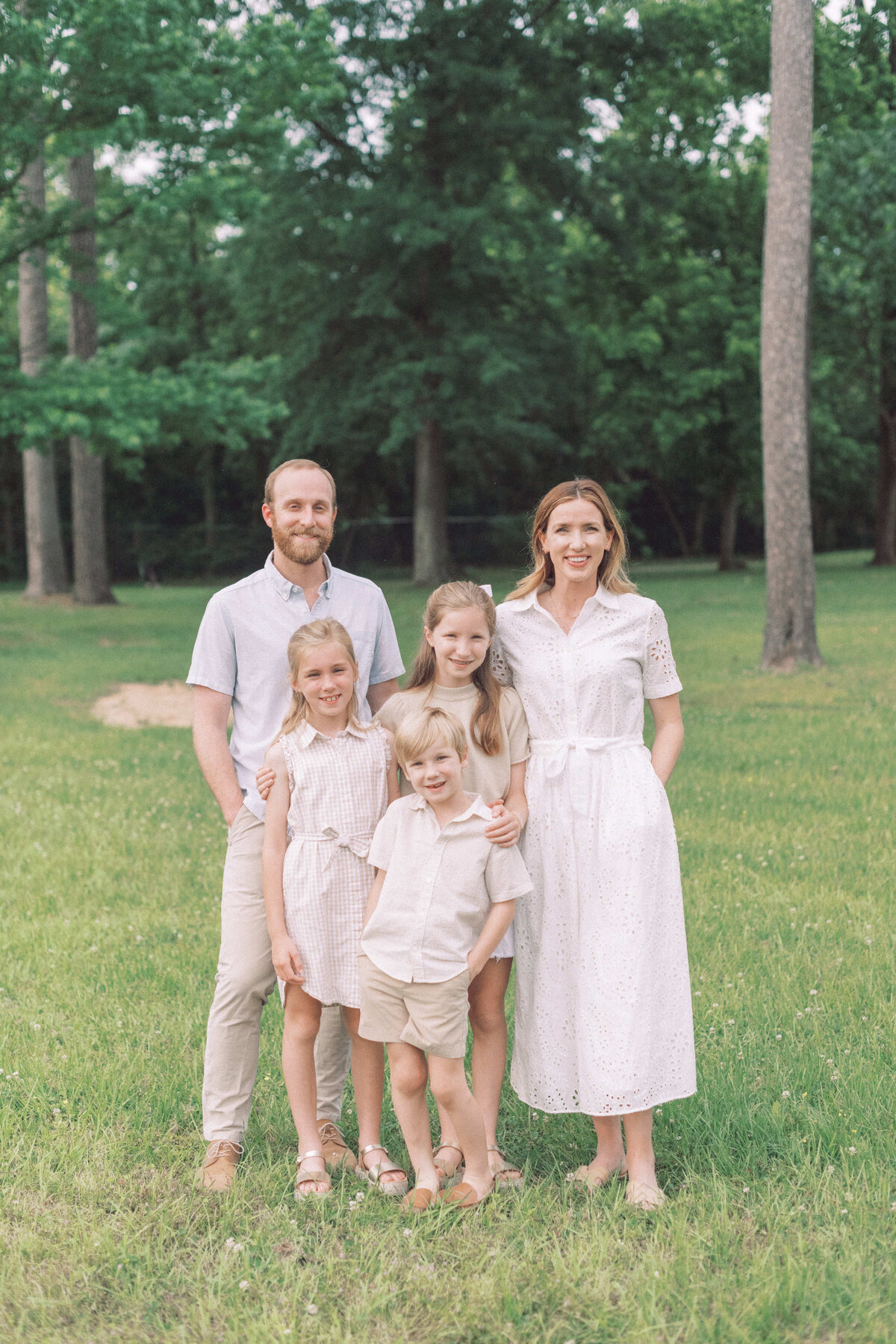 A Homewood Alabama family smiling at the camera in a park