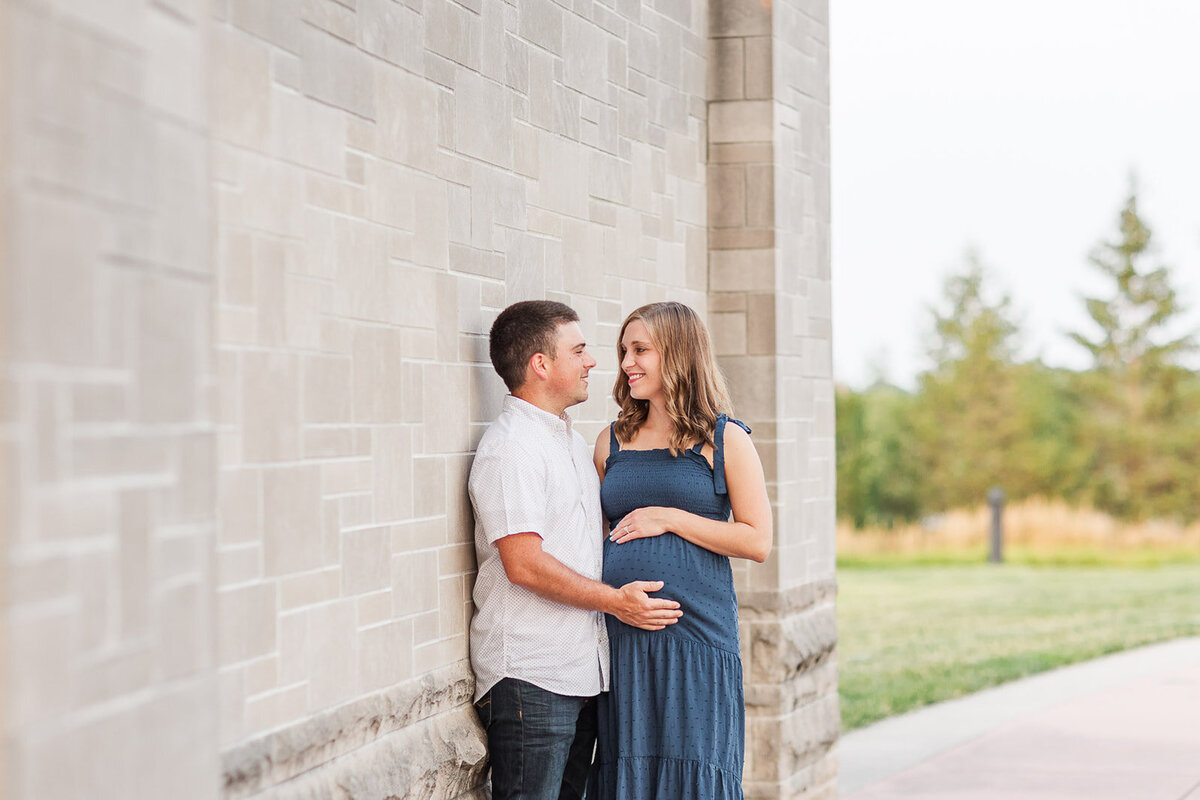 Couple kissing next t a brick wall