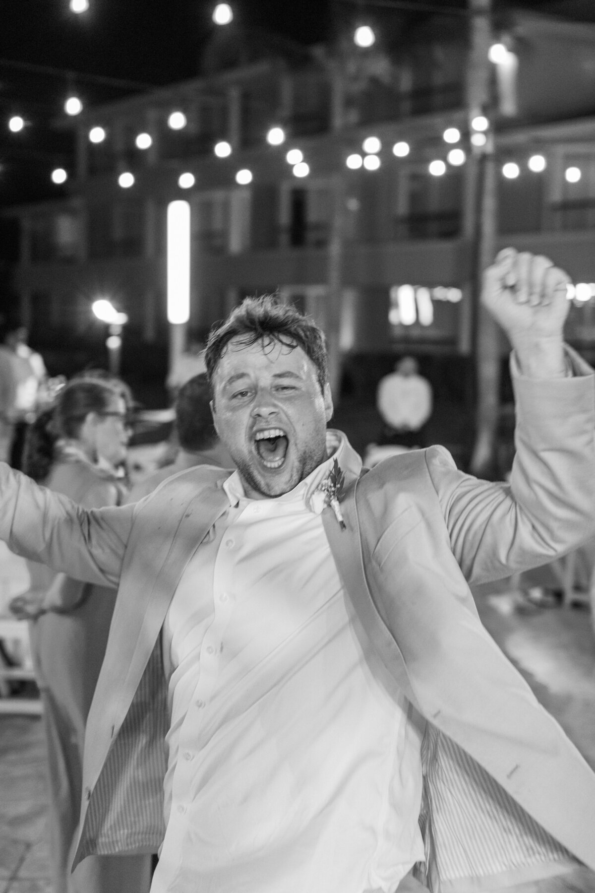 Groom celebrating joyfully on the dance floor at a Cancun wedding, captured by Philadelphia wedding photographer.