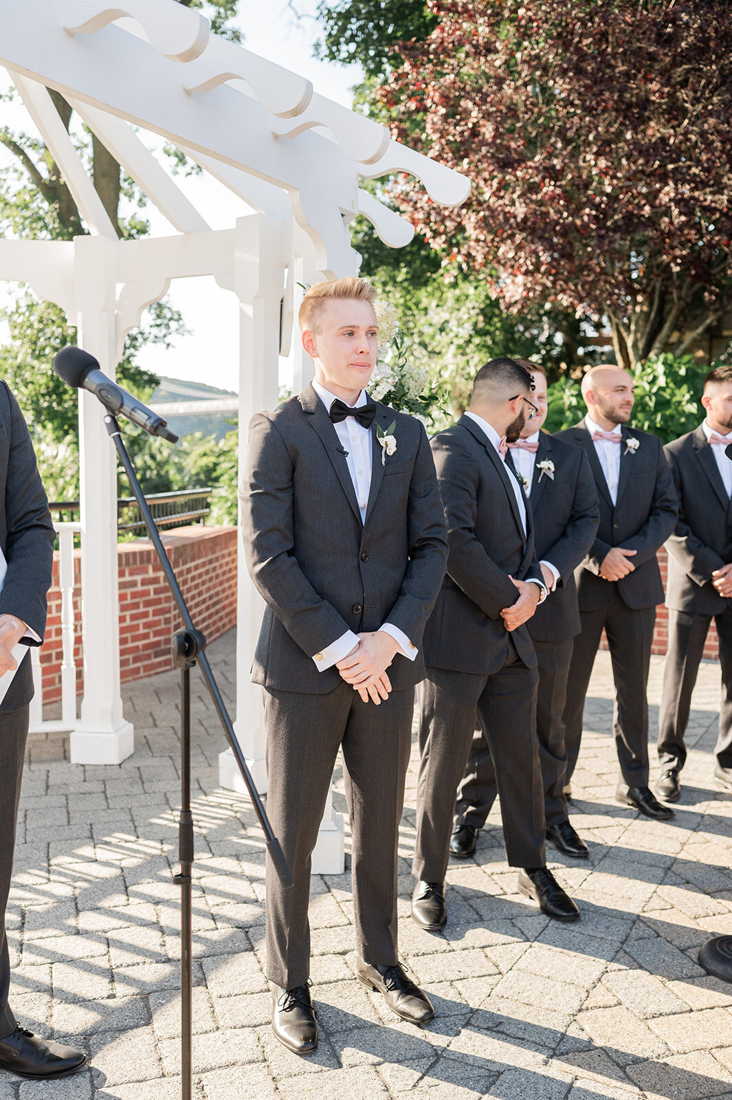 groom watches as bride walks down the aisle