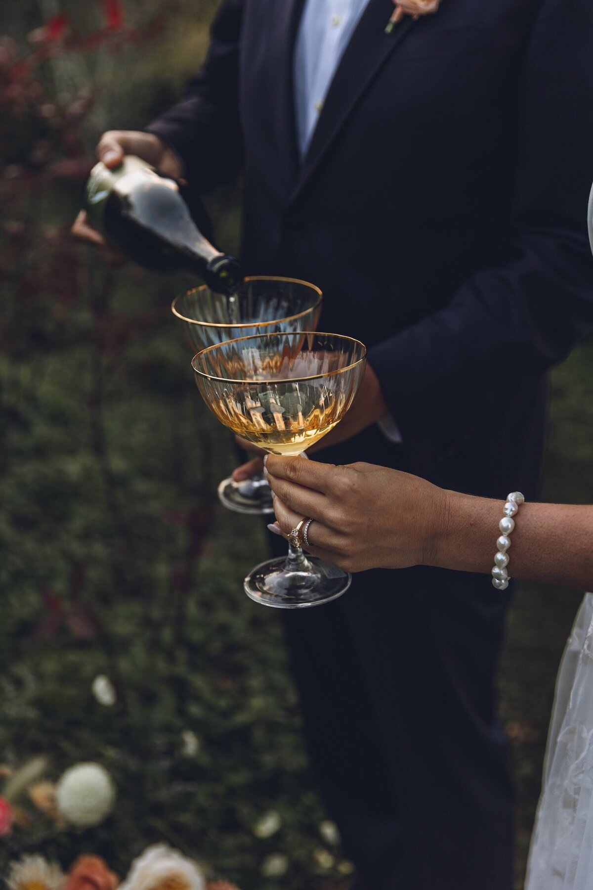Close-up of couple’s hands with champagne glasses