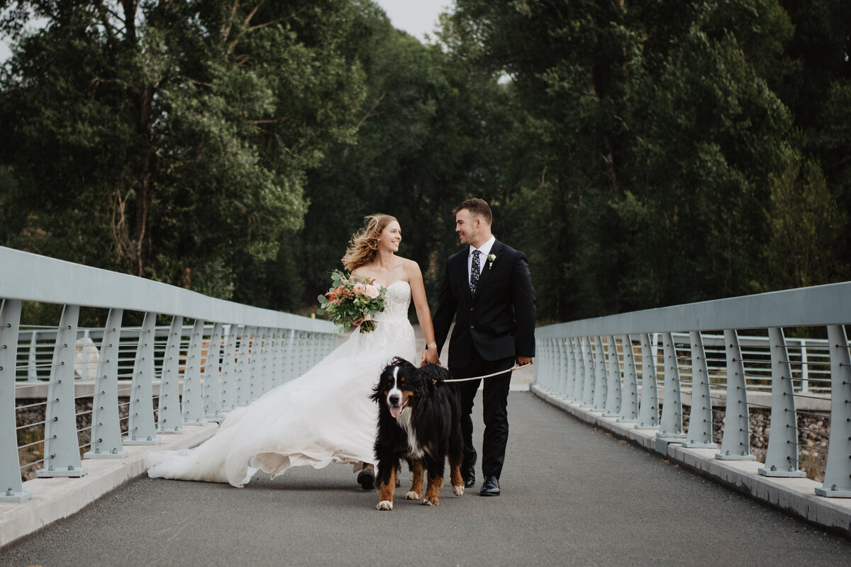 Jackson Hole Photographers capture bride and groom walking dog