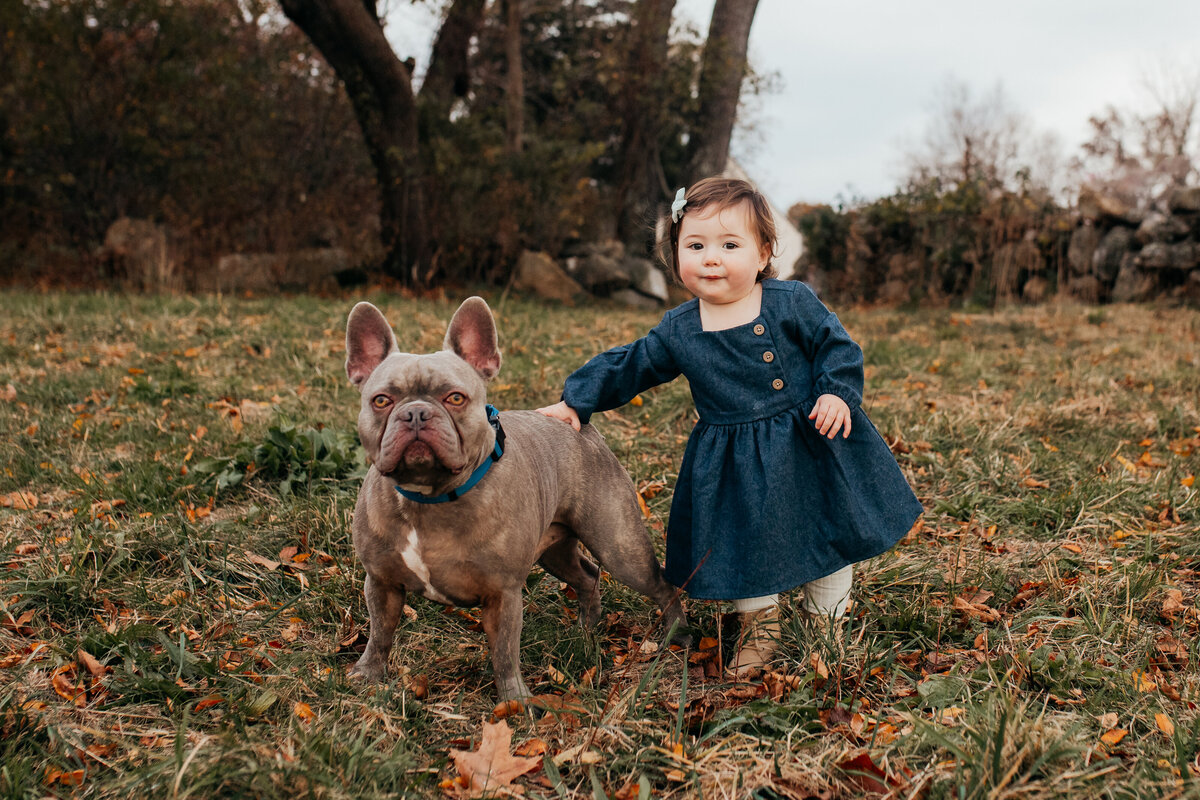 fall family photo of toddler with a dog