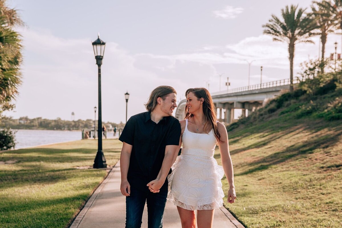 engaged couple walking holding hands at the casement in ormond beach
