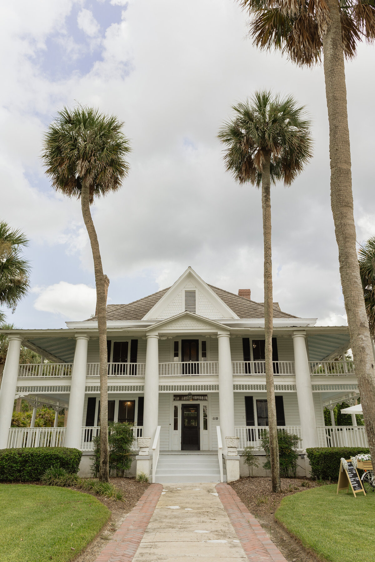Luxury Florida wedding surrounded by tall palm trees and tropical details at The Palm Mansion in Umatilla