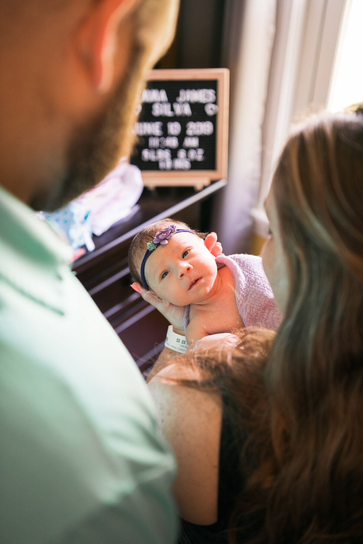 New Hampshire newborn session with baby looking at parents