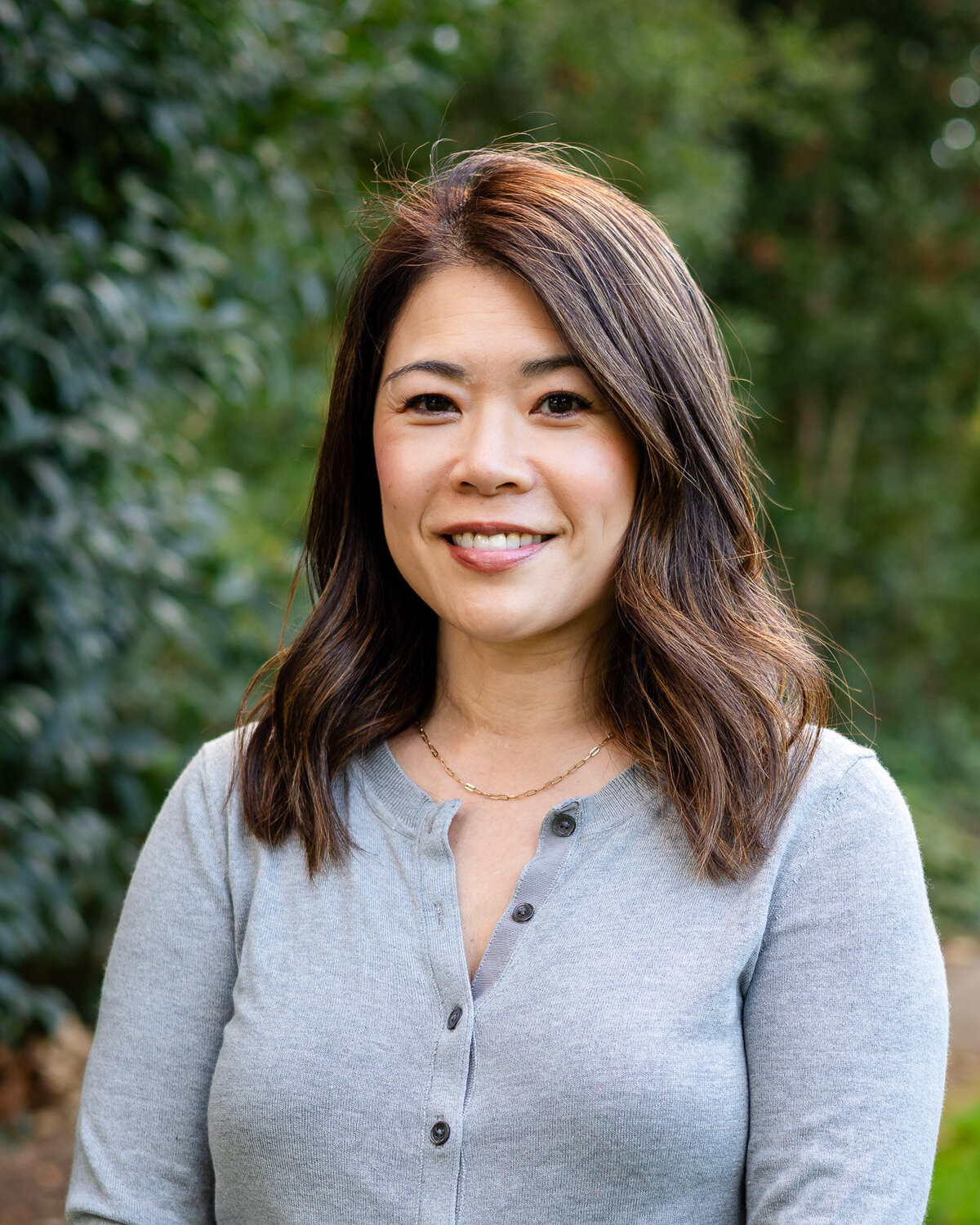 Confident woman smiling in gray sweater outdoors – Bay Area Headshot Portfolio – Ellobelle Photography