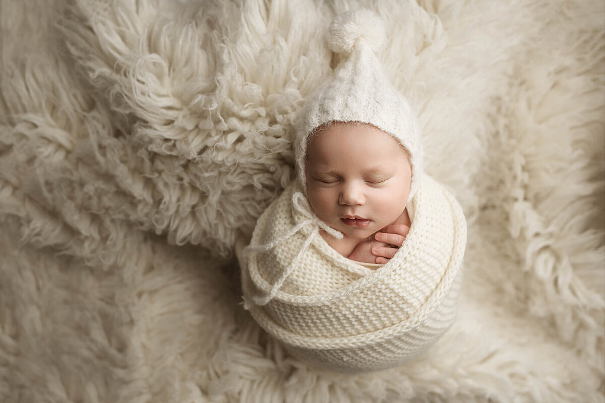 Newborn room with three large statement pieces of artwork.