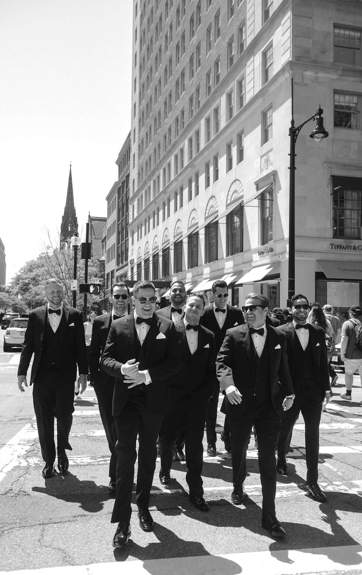 Groom walks across Newbury Street in Boston with Groomsmen.