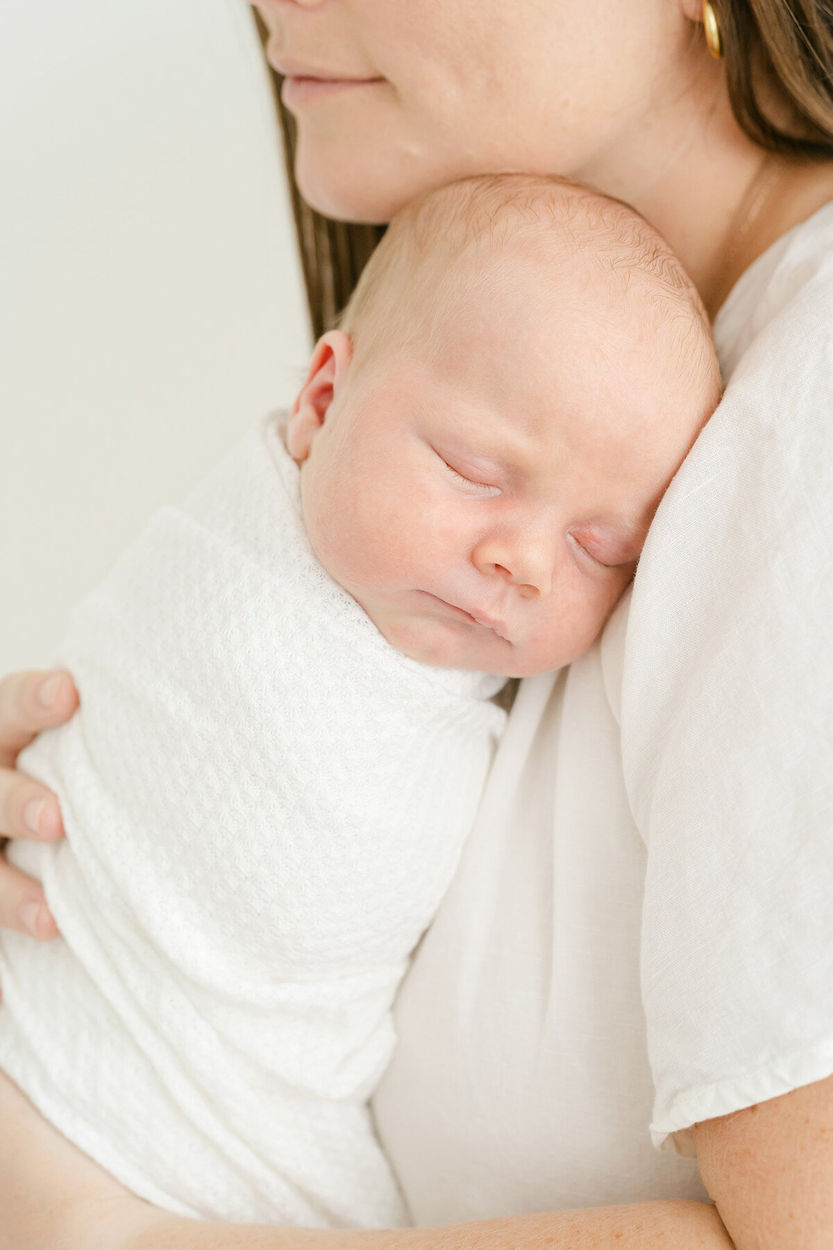newborn baby girl sleeps on mother's shoulder during newborn photo shoot in Kentucky with Julie Brock